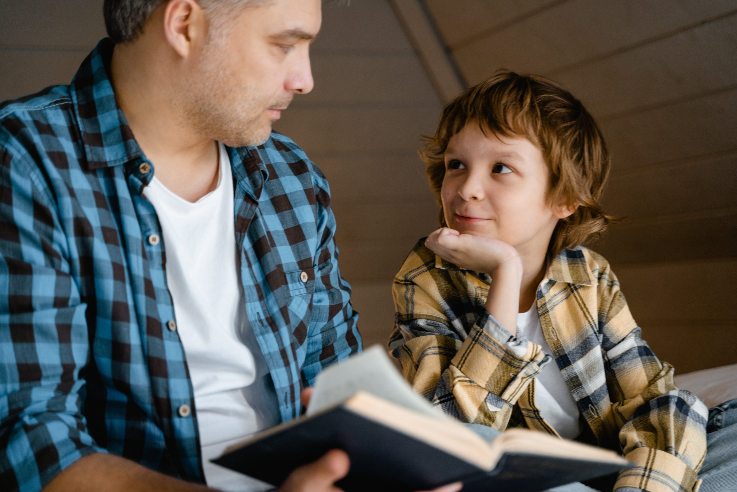 Dad and son reading a book together